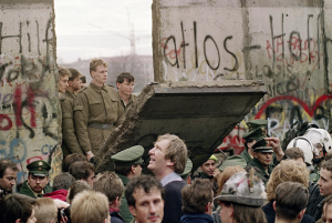screen shot berlin wall coming down in slabs with soldiers